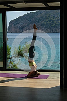 Woman doing yoga in Supported Headstand pose