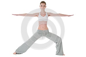 Woman doing yoga, warrior/Virabhadrasana II pose