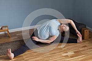 woman doing yoga Wide-Angle Seated Forward Bend pose, Upavishtha Konasana