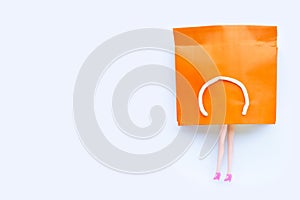 Woman doll  legs with paper shopping bag on white background