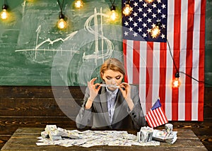 Woman with dollar money for bribe. American education reform at school in july 4th. Economy and finance. Patriotism and