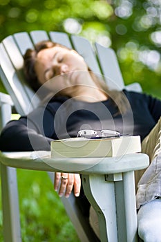 Woman dosing off after reading a book photo
