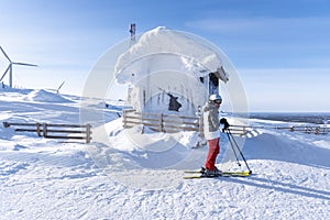 Woman downhill skiing in ski resort area in Lapland Finland