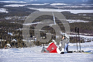 Woman downhill skiing in ski resort area in Lapland Finland