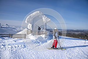 Woman downhill skiing in ski resort area in Lapland Finland