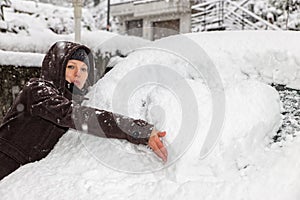 Woman drawing a heart shape on the windscreen