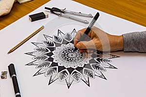 Woman Drawing and Painting a Mandala in Black and White