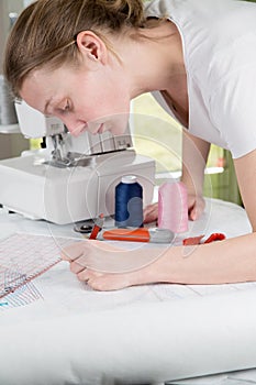 Woman drawing a sewing pattern