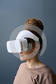 Woman with Dread Bun Wearing VR Headset on Grey