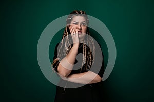 Woman With Dreadlocks Covering Her Mouth