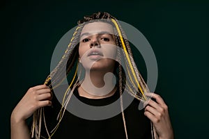 Woman With Dreadlocks Standing in Front of Green Background