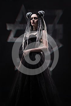 Woman with dreads and festive black gothic dress
