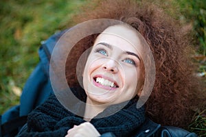 Woman dreaming on green grass outdoors