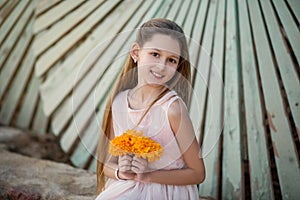 Beautiful girl at sunset in flowers.