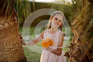 Beautiful girl at sunset in flowers.