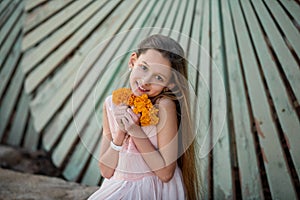 Beautiful girl at sunset in flowers.