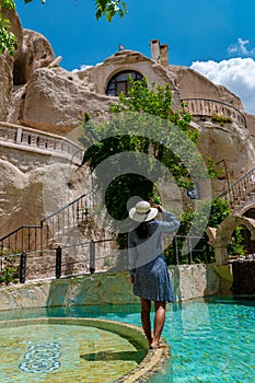 woman in dress at cave house , woman infinity pool cave house hotel in the mountains of Cappadocia