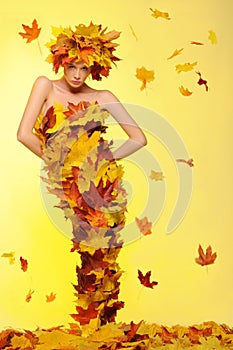 Woman in dress of leaves and defoliation