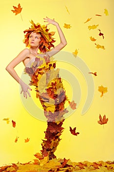 Woman in dress of leaves and defoliation