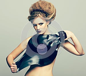 Woman in dress of molten vinyl disk