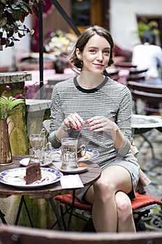 Woman at dress at street cafe drink tea
