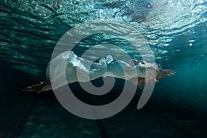 Woman in dress under water.