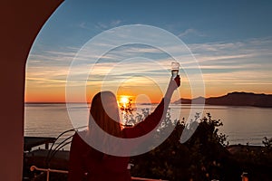 Woman in dress with view from a luxury apartment on the Mediterranean Sea in Praiano, Amalfi Coast, Campania, Italy, Europe.