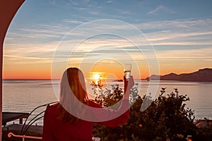 Woman in dress with view from a luxury apartment on the Mediterranean Sea in Praiano, Amalfi Coast, Campania, Italy, Europe.