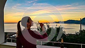 Woman in dress with view from a luxury apartment on the Mediterranean Sea in Praiano, Amalfi Coast, Campania, Italy, Europe.