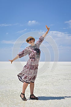 Woman in dress on a white salt lake, portrait of a woman on a white salt lake