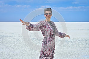 Woman in dress on a white salt lake, portrait of a woman on a white salt lake