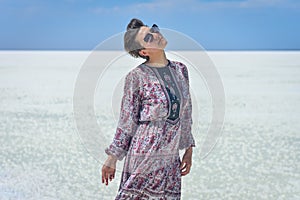 Woman in dress on a white salt lake, portrait of a woman on a white salt lake