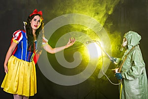 Woman dressed as fairytale character holds Radioactive atomic nuclear ionizing radiation danger warning symbol on apple