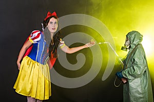 Woman dressed as fairytale character holds Radioactive atomic nuclear ionizing radiation danger warning symbol on apple