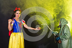 Woman dressed as fairytale character holds Radioactive atomic nuclear ionizing radiation danger warning symbol on apple