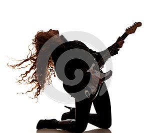 Woman squatting and clutching guitar