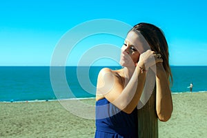 Woman dressed in blue on the beach