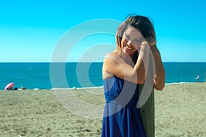 Woman dressed in blue on the beach