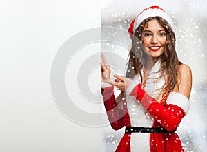 Woman dressed for Christmas showing a blank board