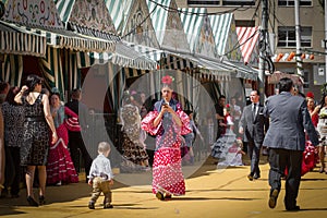 SEVILLE, SPAIN - APR 2014 woman dressed in traditional costume at Feria de Abril on April, 2014 in Seville, Spain