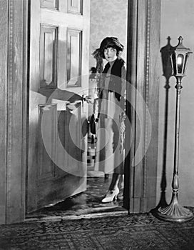 Woman dressed up standing in the doorway