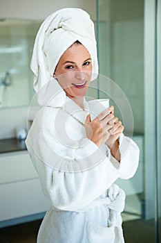 woman in a dressing gown drinking a cup of coffee