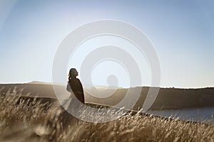 A woman on dried Grass flower in meadow with sun lights