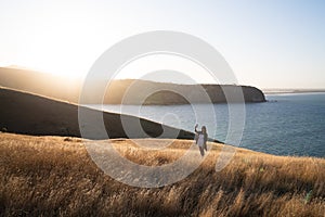 A woman on dried Grass flower in meadow with sun lights