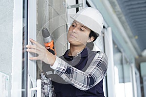 woman drilling with electric power driller