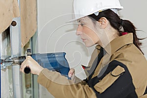 Woman drilling hole using circular attachment
