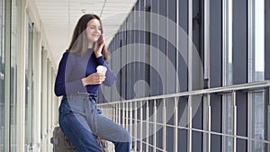 Woman drink coffee inside airport. Flight delay