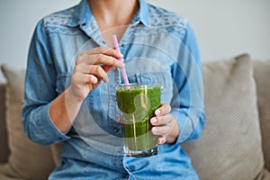 Woman drink healty smoothie with green vegetables