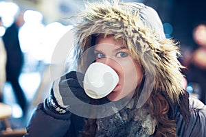 Woman drink hot tea outdoor at winter