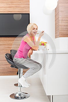 Woman drink orange juice glass in her kitchen